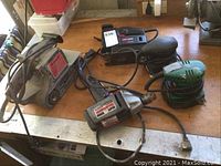 Overall view of the five tools on a workbench showing their condition and cords taped in places.