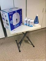 The homedics humidifier in its original packaging, all items on collapsible table