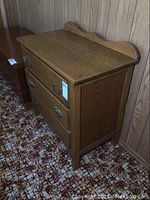 Side angle showing dresser's wood grain, three drawers, and overall condition.