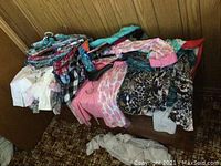 Pile of assorted ladies blouses showing variety of colors, patterns, and styles
