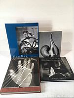 Five photography books arranged standing and flat, showing covers and spines, title details visible