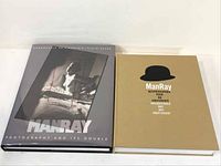Two Man Ray photography monographs side by side, showing the beige cover and the dust jacket