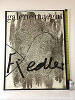 Full shot of the framed original lithograph poster by Francois Fiedler with measuring tape and soda can for size reference.