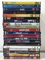 Full stack of 20 DVDs spanning dramas, romances, thrillers. Titles readable on spines.