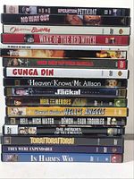 Photo showing a stack of 18 DVD cases, all war/action movies, titles visible on spines.