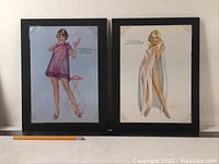 Two Vargas Girl prints side by side in black frames shown with measuring pencil in front for scale.