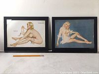 Two framed Vargas Girl prints side by side, shrink-wrapped for protection, placed on a white surface with a pencil for size reference.
