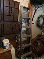 6-foot folding step ladder leaning against a wall, showing overall condition and environment