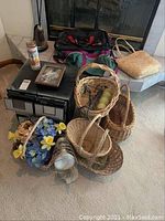 Photo showing full lot including wicker baskets, bags, VHS storage, sunlamp, decorative items.