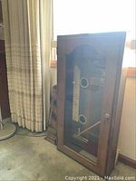 Exterior view of wooden display case with glass door