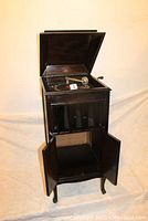 Full front view with top lid and lower cabinet doors open showing cabinet structure and mechanism