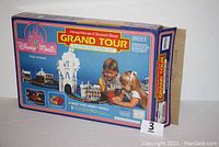 Original box for the Disney Magic Grand Tour Electric Road Racing Set showing packaging artwork with Mickey Mouse, Donald Duck, and children playing with the set.