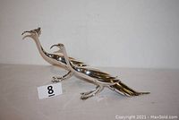 Pair of silver-plated peacock-pheasants shown together from side view to highlight size and shape.