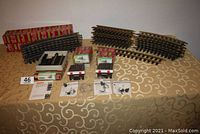Wide view showing all track pieces and accessories including boxed items and loose track curves and straights on table