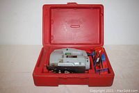 Pencrest sabre saw inside its open red plastic case with blades stored in one compartment