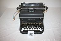 Front view of Remington Rand Model 17 typewriter showing round keys and model name plate.