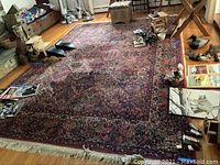 Full view of rug laid on hardwood floor with fringe visible