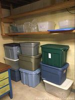 Photo of stacked opaque plastic bins in blue, gray, beige, and green colors