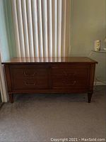 Full view of the cedar chest showing wooden construction, rectangular shape, and tapered legs.