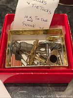 Photo of assorted cufflinks and tie tacks including the 10K gold tie tack by Swank with handwritten note