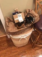 Woven clothes hamper with fabric liner and duffle bags inside