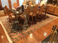 Full view under dining table showing overall pattern and fringe