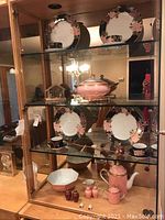 Curio cabinet display with Cloisonne Peony plates, cups, pink serveware