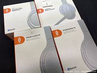 Four boxed audio headset products including three Twelve South SoundSurge 90 Active Noise Cancelling Wireless Stereo Headphones and one Wireless Mono Headset all in retail boxes.