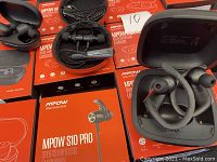 Another close-up of Mpow S10 Pro earbuds showing inner charging contacts and silicone ear tips for condition and model verification.