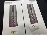 Two boxed HTD brand hair styling tools. Boxes are white with HTD logo and picture of the tool on the front.