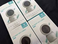 Four boxed HeimVision HD Smart WIFI Cameras with model HV203 shown on boxes.