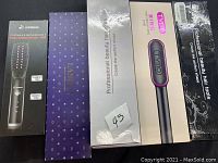 Lot showing the boxed beauty hair tools including the Dipmend straightening comb, Lanmei branded box, Tymo Ring curling iron, and a professional hair tool box.