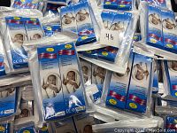 Multiple sealed packages of baby digital thermometers showing product packaging with infant image on cover.