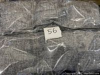 Close-up of grey charcoal filter fabric wrapped in plastic.