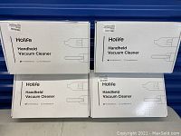 Four retail boxes of Holife handheld vacuum cleaners stacked, showing brand and product name.