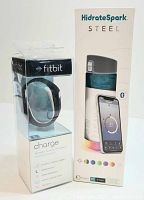 Packaging of Fitbit Charge wireless activity wristband showing front with product name and features.