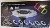 Box with 8-pack LED Solar Ground Disk Light showing solar panel, waterproof icon, and LED label on front