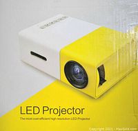 Front and side view of LED projector showing lens, control buttons, and partial side vents.