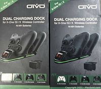 Two Omvo Dual Charging Dock packages side by side, each showing images of the charging dock with controllers and power adapter on the box. Boxes are labeled for Xbox One (S)/X controllers, mention Ni-MH batteries included.
