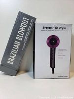 Photo showing Brazilian Blowout box and Breeze Hair Dryer box side by side.