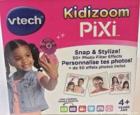 Close up of Vtech Kidizoom Pixi boxed packaging showing pink branding and child using camera with text about photo filter effects and age 4+.