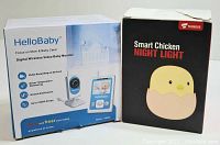 Boxes for HelloBaby Digital Wireless Video Baby Monitor and Tecboss Smart Chicken Night Light showing branding and features.