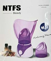 Facial steamer device in purple and white plastic, shaped for facial and nose steaming with adjustable control knob, shown on product box