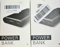 Two boxed solar power banks shown in white retail packaging labeled POWER BANK with barcode stickers.