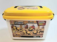 Front view of yellow toy storage case showing 7-in-1 construction truck set with 68 pieces and age recommendation 3+.