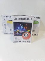 Three boxes of new LED Music Bulbs showing front packaging labeled 'LED Music Bulb'
