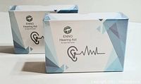 Two sealed Enno hearing aid boxes side by side showing branding and design on front.