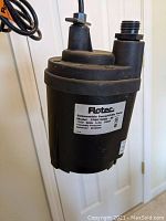 Overall front view of the black Flotec submersible sump pump showing label with model and electrical specifications.