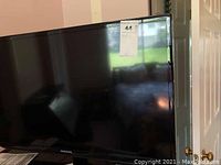 Front view of Samsung 32-inch flat screen TV with label on top right corner.