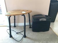 Photo showing wooden health aid stool next to black Hunter air purifier on carpeted floor.